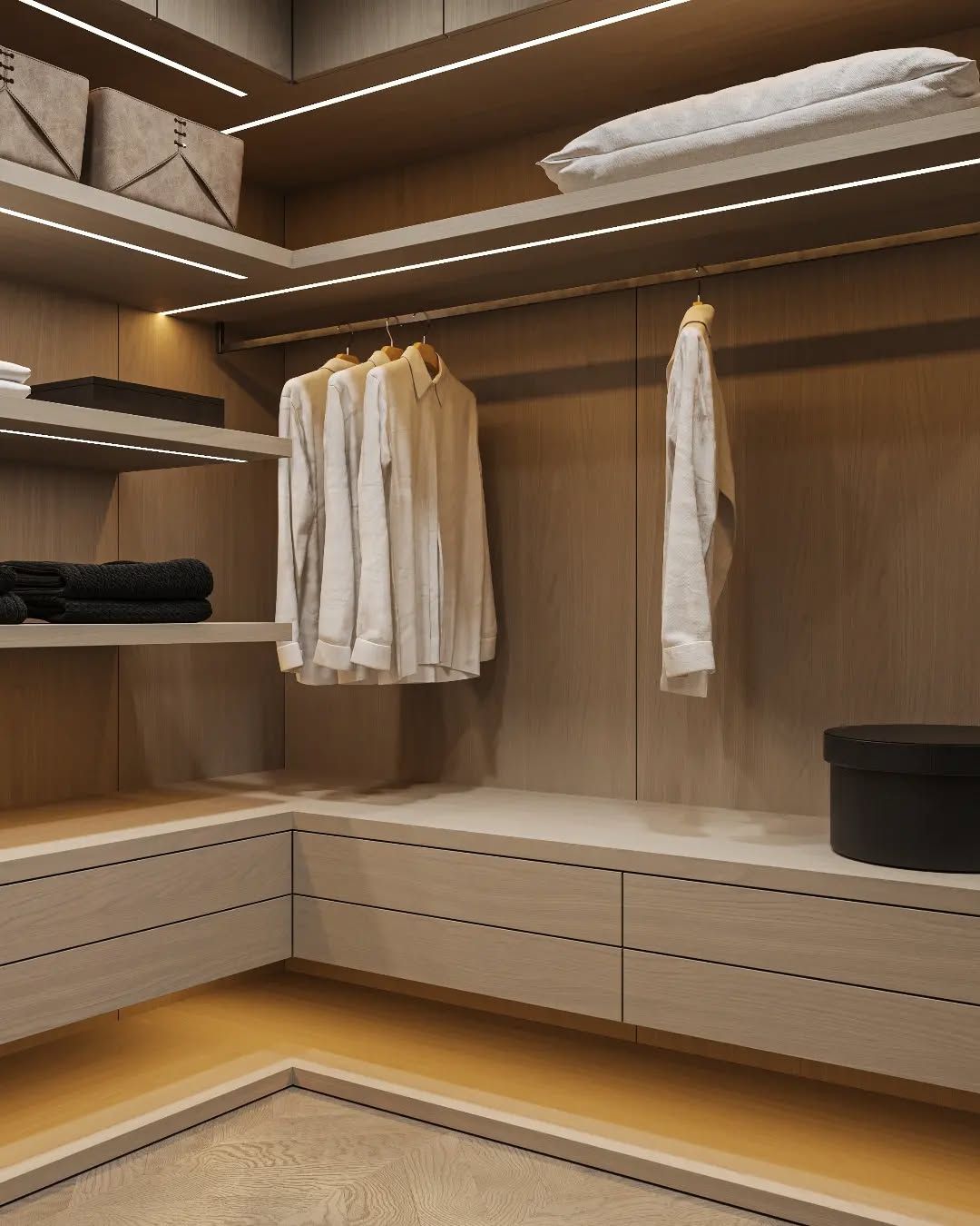 Corner view of minimalist walk-in closet with drawers and ambient strip lighting | Al Janah Al Malaky
