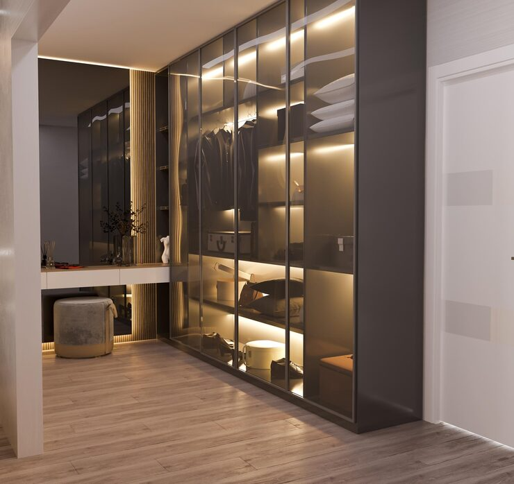 Modern walk-in closet with glass doors and built-in lighting | Al Janah Al Malaky