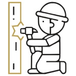 A builder wearing a hard hat hammering a nail into wood | Al Janah Al Malaky