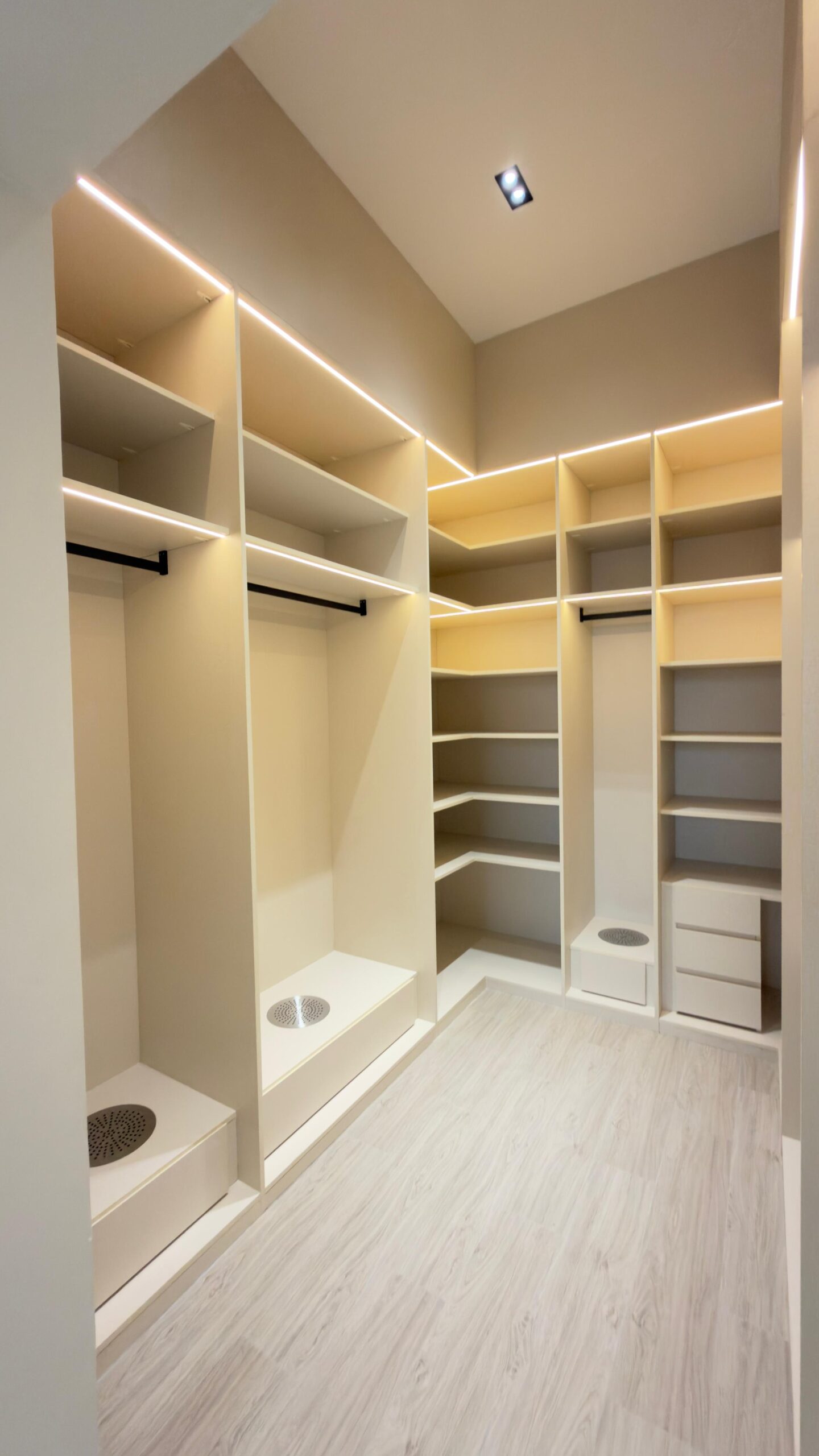 A modern walk-in closet with built-in shelving and lighting | site title "Al Janah Al Malaky"